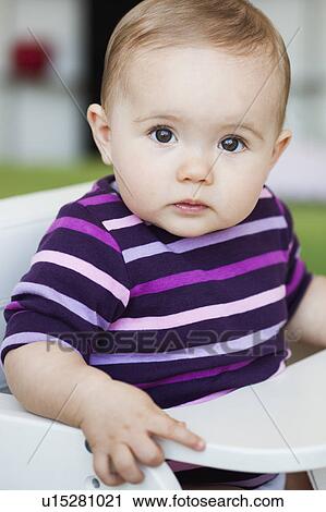 baby sitting in chair looking at viewer View Large Photo Image Stock Image - baby sitting in chair looking at viewer. Fotosearch