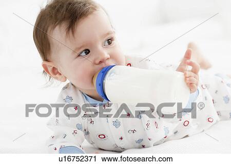 Stock Image - baby sucking bottle. Fotosearch