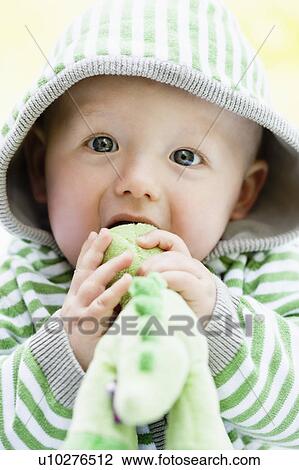 Stock Image - baby with dino-toy. Fotosearch