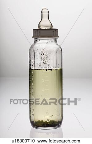 Stock Image - Baby's bottle with dirty water. Fotosearch