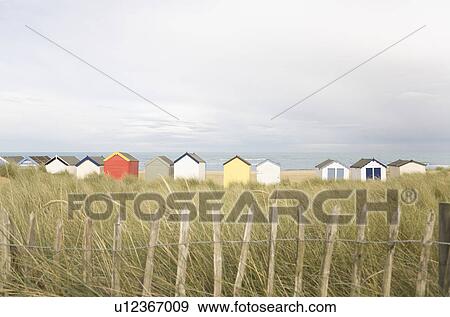 Beach huts behind fencing View Large Photo Image Stock Photo - Beach huts behind fencing. Fotosearch