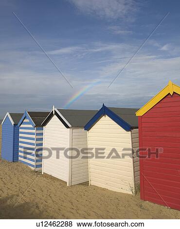 Stock Photo - Beach huts with rainbow. Fotosearch