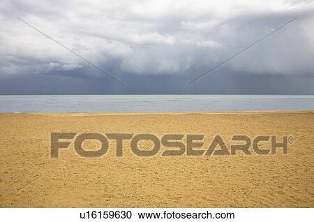 Stock Image - Beach with brooding sky. Fotosearch