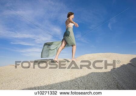 Stock Image - Beautiful woman in the sun. Fotosearch