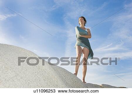 Stock Image - Beautiful woman in the sun. Fotosearch