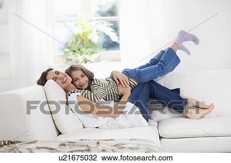 Stock Image - big and little girl cuddling. Fotosearch