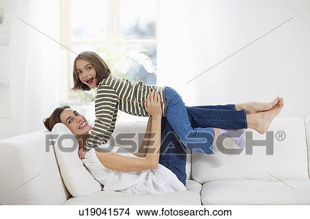 big and little girl joking on the sofa View Large Photo Image Picture - big and little girl joking on the sofa. Fotosearch
