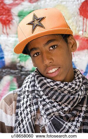 Black Teenager against graffiti wall View Large Photo Image Stock Image - Black Teenager against graffiti wall. Fotosearch
