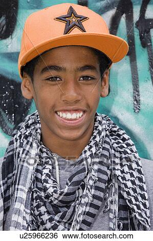 Stock Photograph - Black Teenager against graffiti wall. Fotosearch