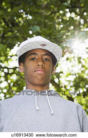 Black Teenager in a park with lens flare View Large Photo Image Stock Image - Black Teenager in a park with lens flare. Fotosearch