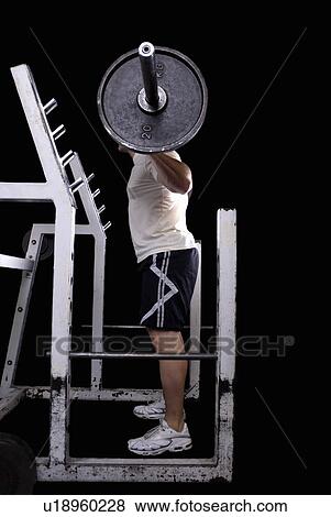 Stock Photo - bodybuilder about to squat. Fotosearch