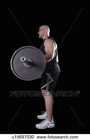 Stock Image - bodybuilder doing biceps curls. Fotosearch