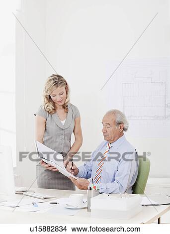 Picture - Boss signs document. Fotosearch