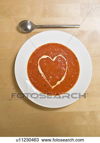 Stock Image - Bowl of soup with love heart cream. Fotosearch