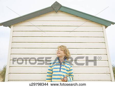 Boy against beach hut View Large Photo Image Picture - Boy against beach hut. Fotosearch