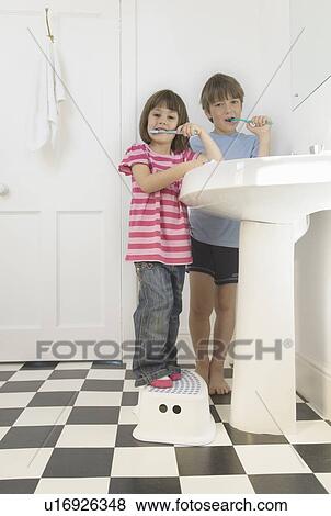 Stock Photo - Boy and Girl cleaning teeth. Fotosearch