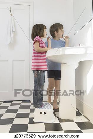 Stock Photo - Boy and Girl cleaning teeth. Fotosearch