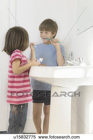Stock Photography - Boy and Girl cleaning teeth. Fotosearch