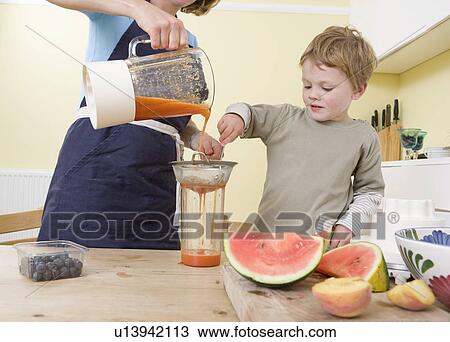 boy and mum making fruit smoothies View Large Photo Image Stock Image - boy and mum making fruit smoothies. Fotosearch