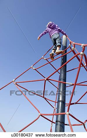 Boy climbing junglegym View Large Photo Image Stock Photo - Boy climbing junglegym. Fotosearch