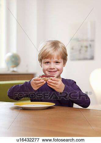 boy eating bread roll View Large Photo Image Stock Photo - boy eating bread roll. Fotosearch