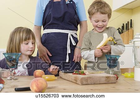 boy, girl and mother preparing fruit View Large Photo Image Stock Image - boy, girl and mother preparing fruit. Fotosearch