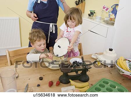 boy, girl and mum making fruit muffins View Large Photo Image Stock Photo - boy, girl and mum making fruit muffins. Fotosearch