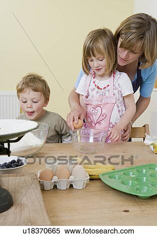 boy, girl and mum making fruit muffins View Large Photo Image Stock Photography - boy, girl and mum making fruit muffins. Fotosearch