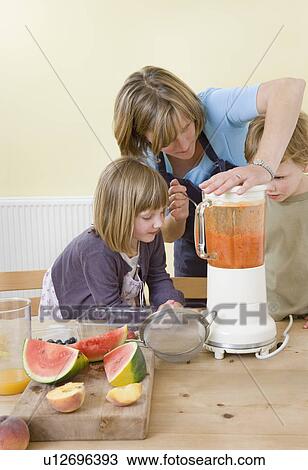 boy, girl and mum making fruit smoothies View Large Photo Image Stock Image - boy, girl and mum making fruit smoothies. Fotosearch