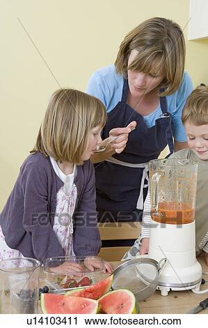 boy, girl and mum making fruit smoothies View Large Photo Image Stock Image - boy, girl and mum making fruit smoothies. Fotosearch