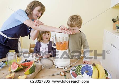 boy, girl and mum making fruit smoothies View Large Photo Image Stock Photography - boy, girl and mum making fruit smoothies. Fotosearch
