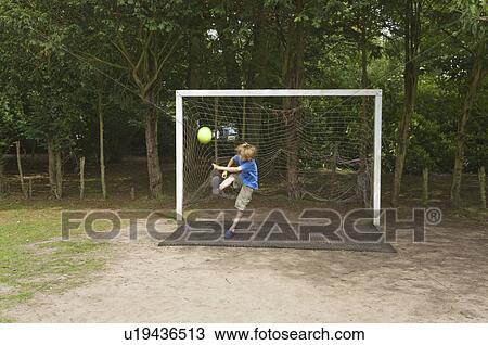Boy in goal playing football View Large Photo Image Stock Image - Boy in goal playing football. Fotosearch