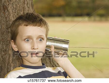 Stock Photo - Boy Listening to Tin Can Phone. Fotosearch