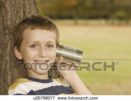 Stock Photo - Boy Listening to Tin Can Phone. Fotosearch