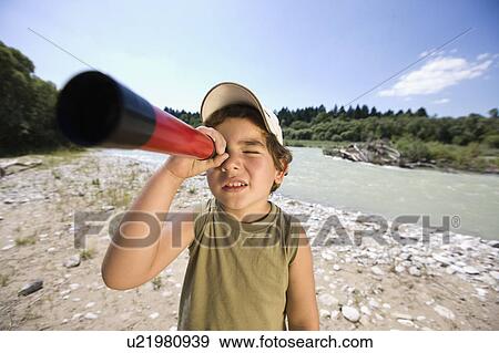 Stock Photo - boy looking through a telescope. Fotosearch