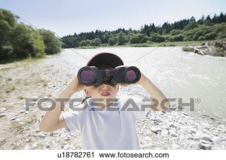 Stock Image - boy looking through field glasses. Fotosearch