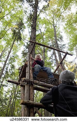Stock Image - Boy on a perch. Fotosearch