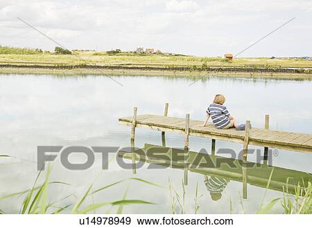 Stock Photo - Boy on jetty. Fotosearch