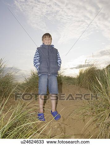Boy on sand dunes View Large Photo Image Stock Image - Boy on sand dunes. Fotosearch