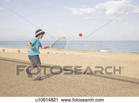 Boy playing tennis on promenade View Large Photo Image Stock Image - Boy playing tennis on promenade. Fotosearch