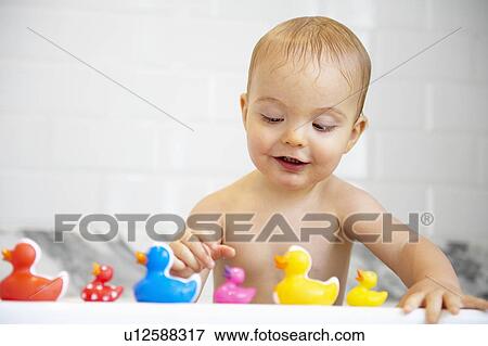 Boy playing with plastic ducks in bath View Large Photo Image Stock Photo - Boy playing with plastic ducks in bath. Fotosearch