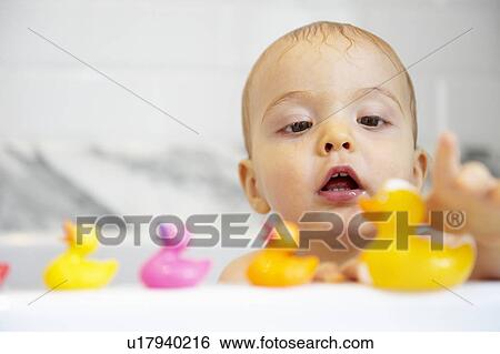 Boy playing with plastic ducks in bath View Large Photo Image Stock Photograph - Boy playing with plastic ducks in bath. Fotosearch