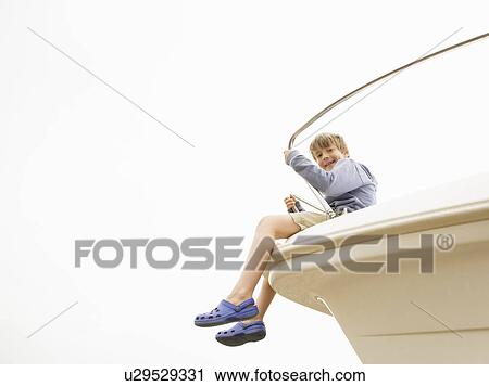 Boy sitting on bow of yacht View Large Photo Image Stock Image - Boy sitting on bow of yacht. Fotosearch