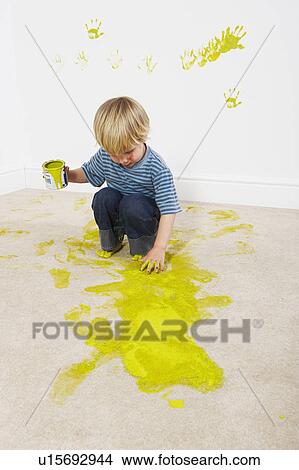 Boy sloshing paint onto carpet View Large Photo Image Picture - Boy sloshing paint onto carpet. Fotosearch