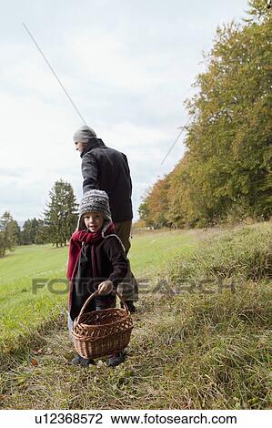 Stock Image - Boy with basket looking back . Fotosearch