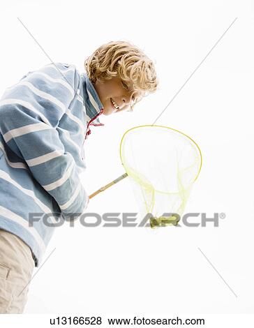 Stock Photo - Boy with crab in net. Fotosearch