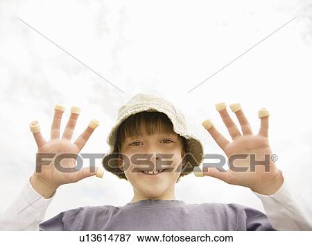 Boy with hoop crisps on fingers View Large Photo Image Stock Photo - Boy with hoop crisps on fingers. Fotosearch