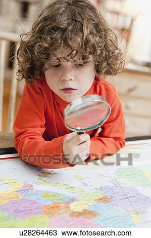 Stock Image - boy with magnifying glass. Fotosearch