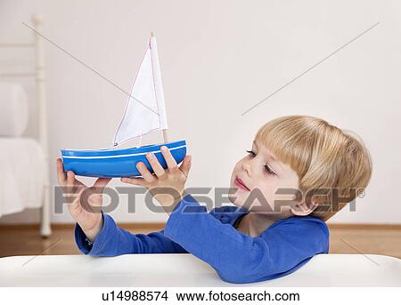 boy with toy boat View Large Photo Image Picture - boy with toy boat. Fotosearch