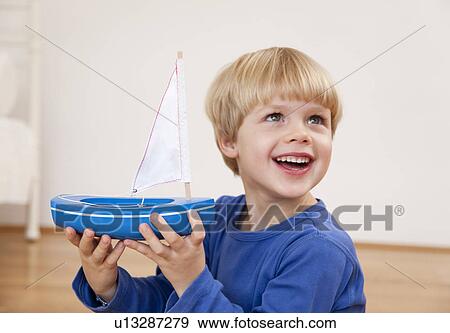 boy with toy boat View Large Photo Image Stock Photo - boy with toy boat. Fotosearch